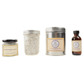 A variety of culinary lavender products , including lavender salt in a glass jar, dried lavender in a tin, and lavender extract in a small bottle