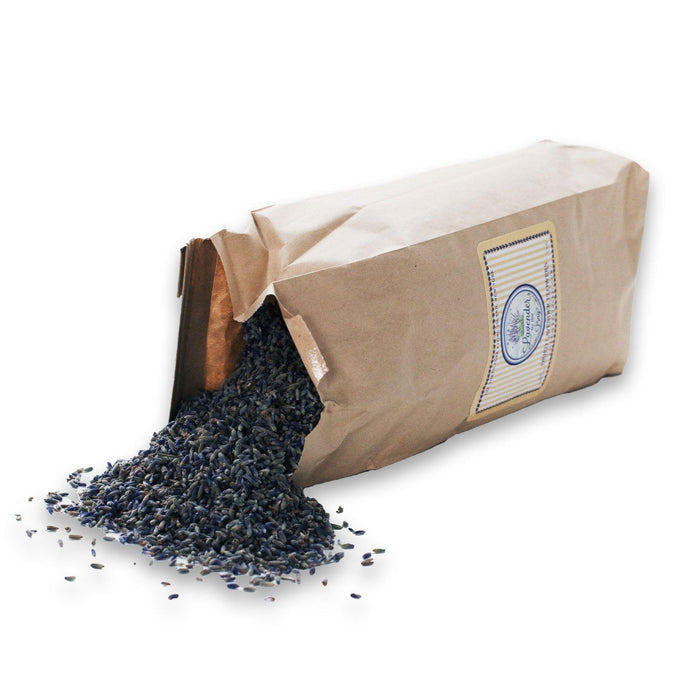 A half-pound of dried French lavender buds. The lavender buds are light purple color and spilled out of a narrow paper bag