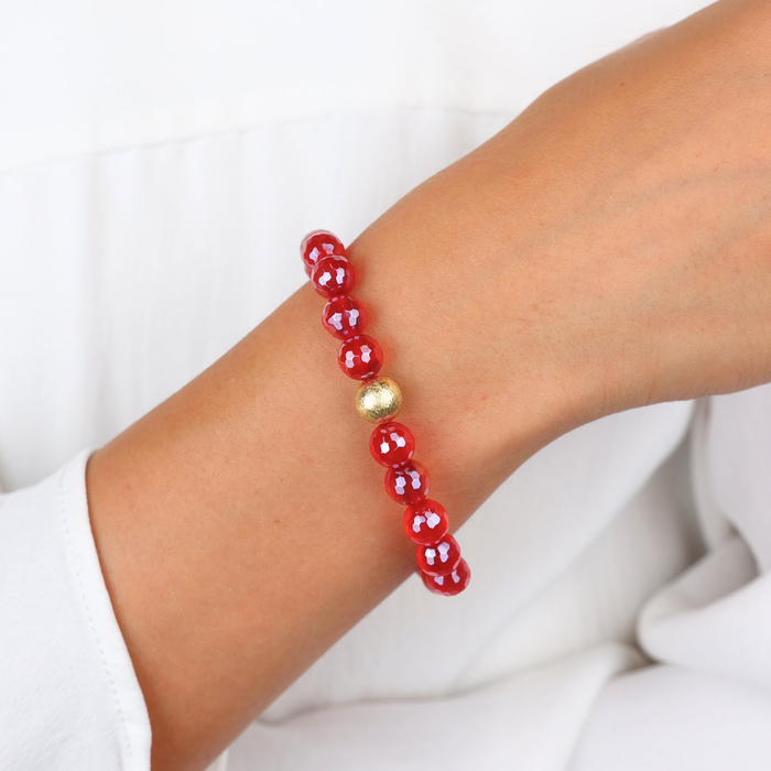 BuDhaGirl red beaded bracelet with faceted crimson beads and a single gold accent bead worn on a wrist