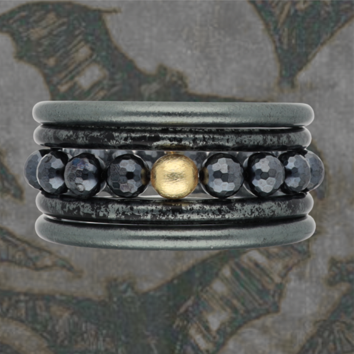 a ring with a gold ball in the middle